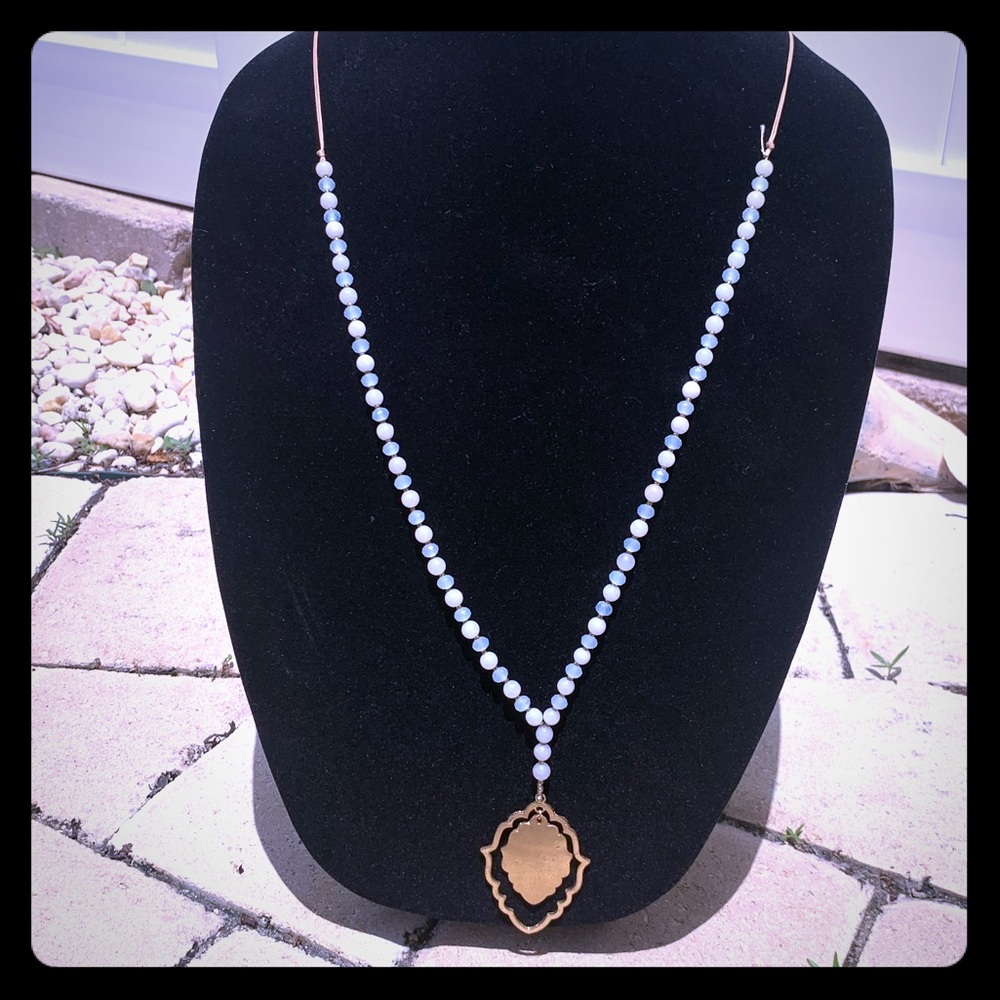 Pale blue bead with gold medallion necklace